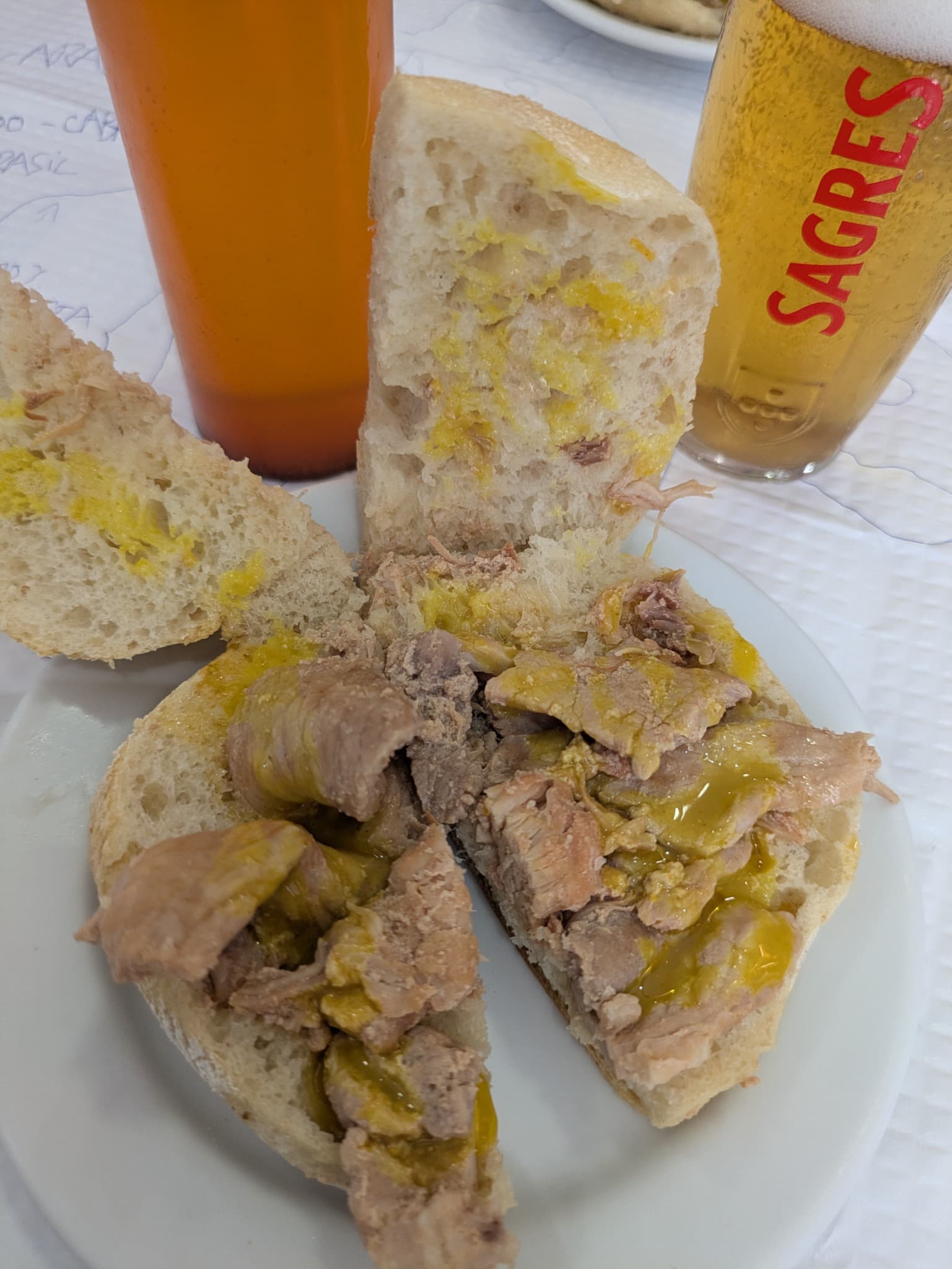 A traditional bifana served with Portuguese beer