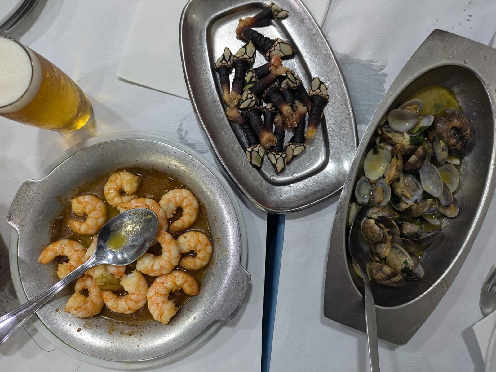 A shared table of prawns, clams and percebes