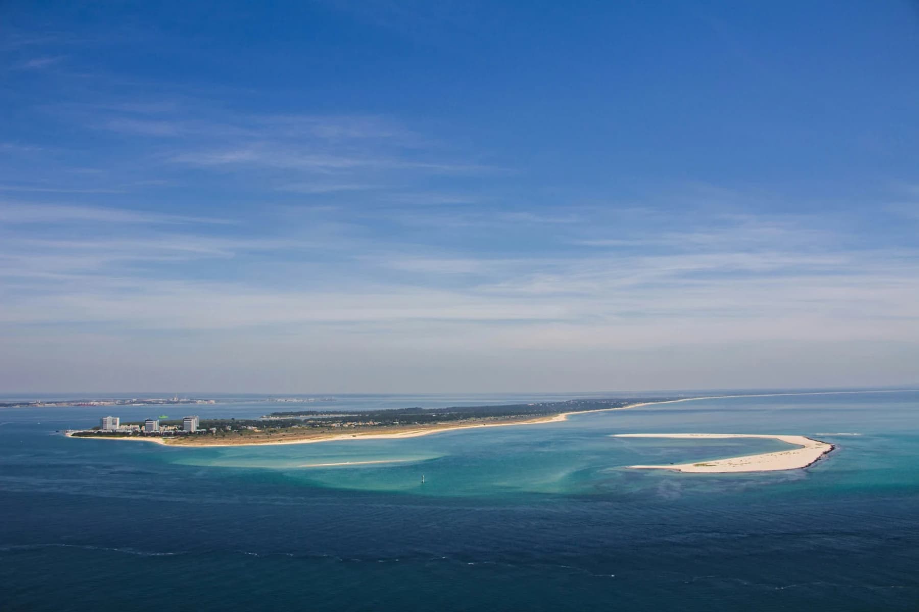 Blue water and sweeping sandbanks at the mouth of the Sado estuary
