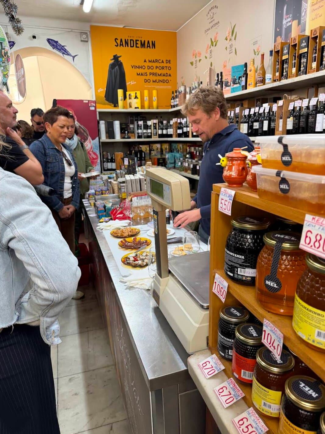 A tasting with guests at the counter of a local shop
