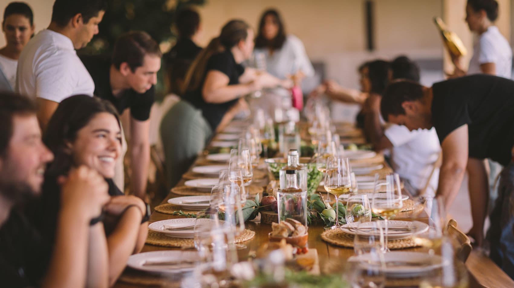 Guests gathering around a long table for a wine experience at Fita Preta