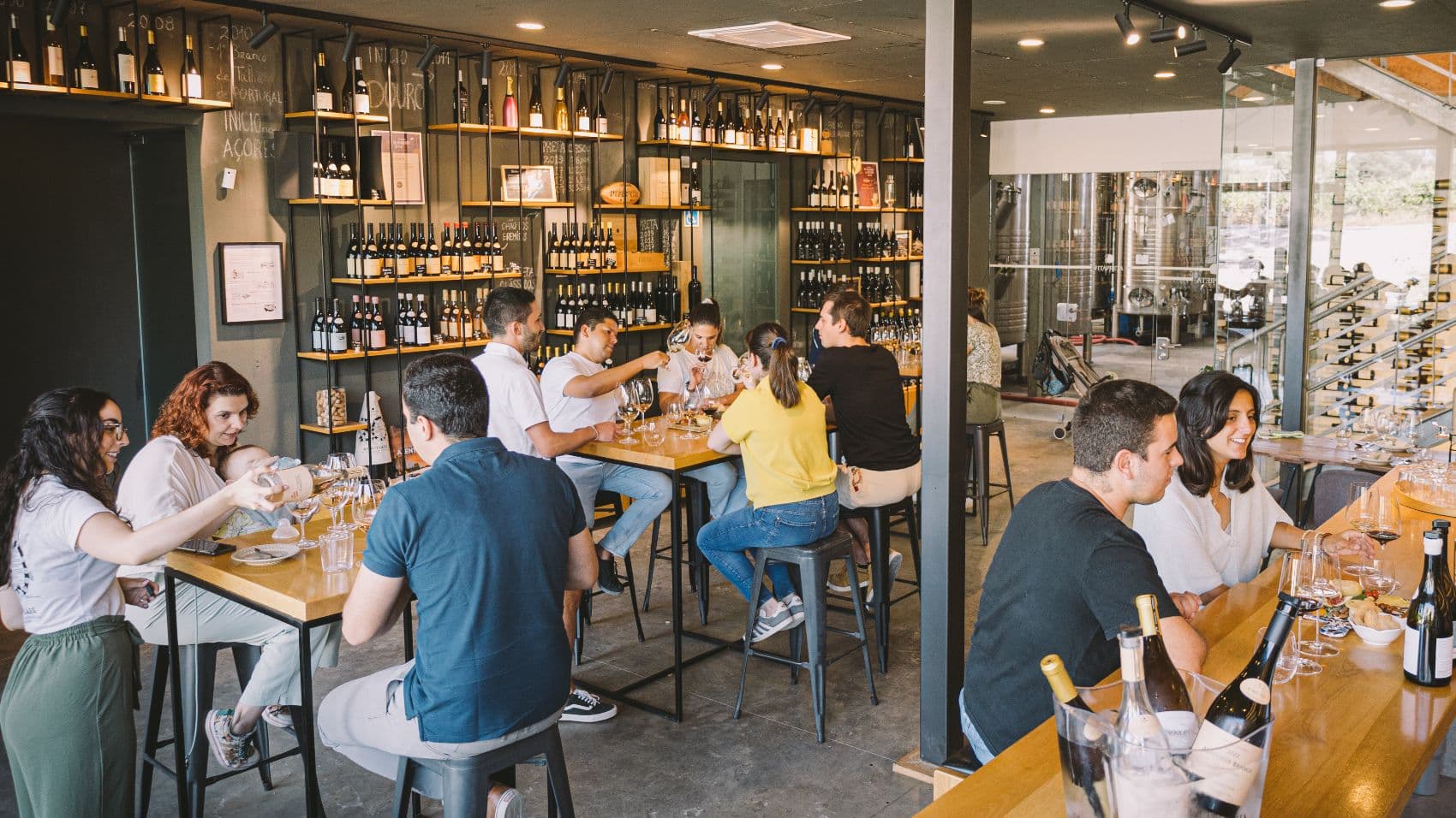 Guests tasting wine inside Fita Preta’s contemporary wine bar