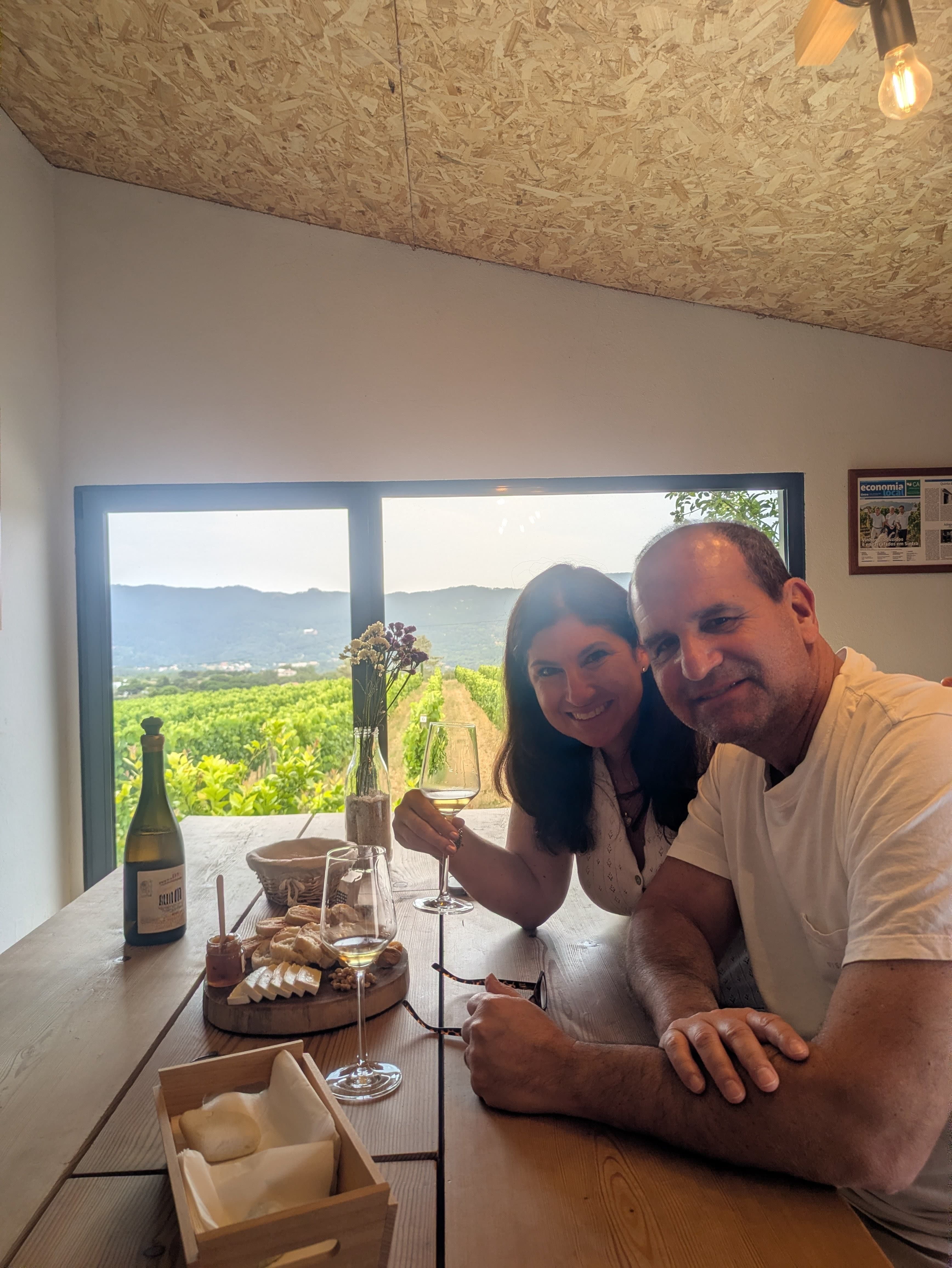 Guests enjoying wine and regional products overlooking vineyards