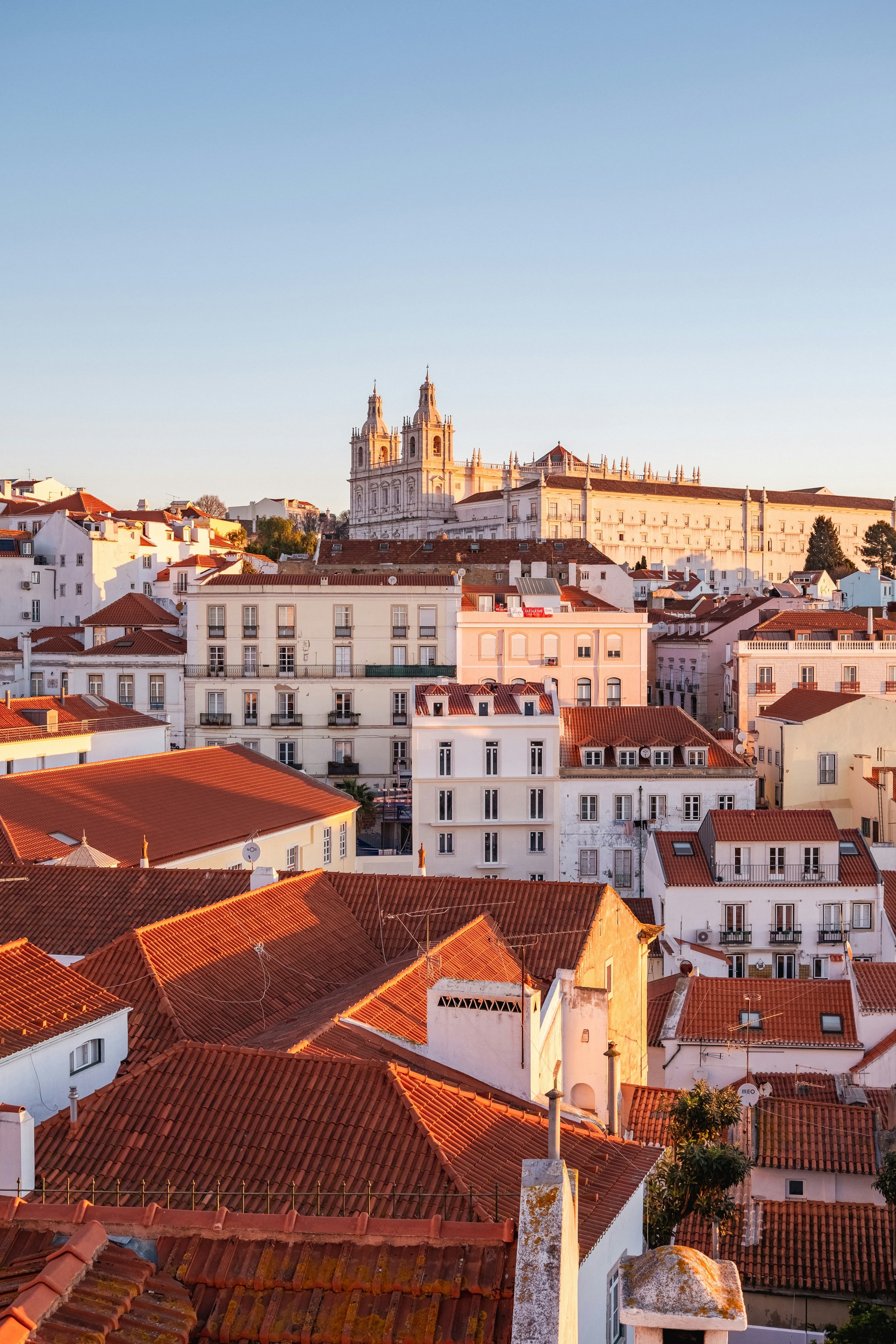 Lisbon rooftops glowing in warm evening light