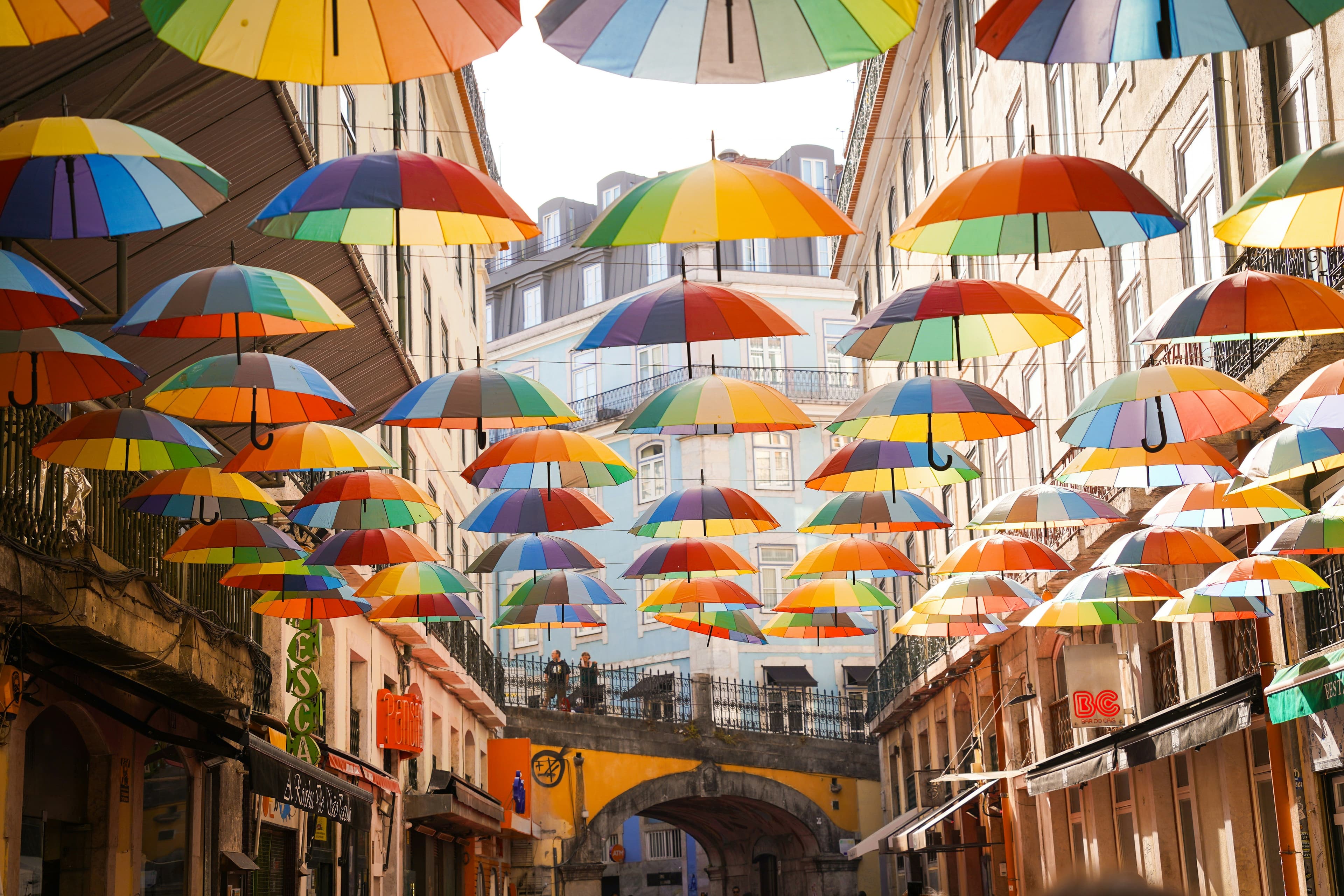 Colorful umbrellas suspended above a Lisbon street