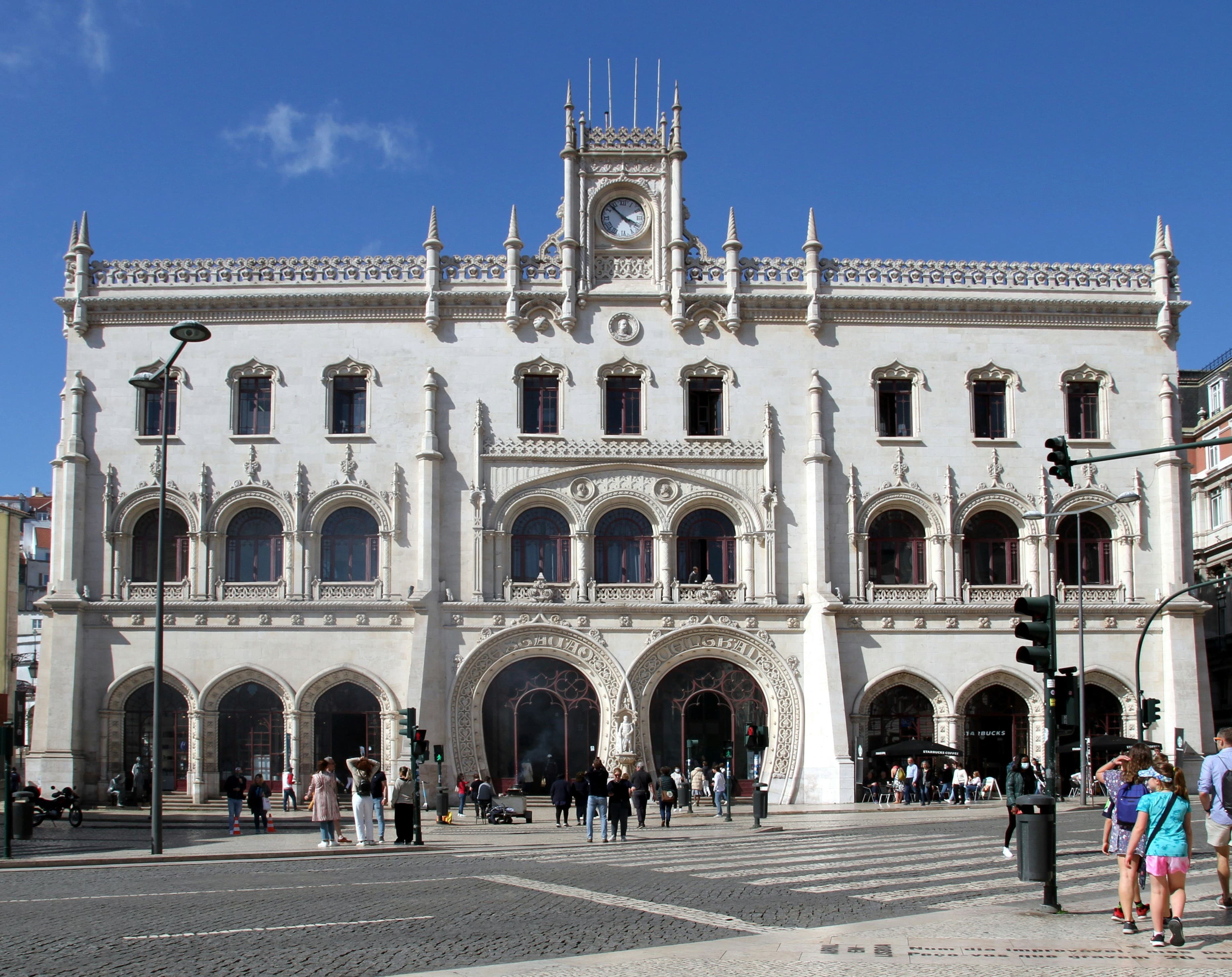 Two Lisbon trams meeting on a steep historic street