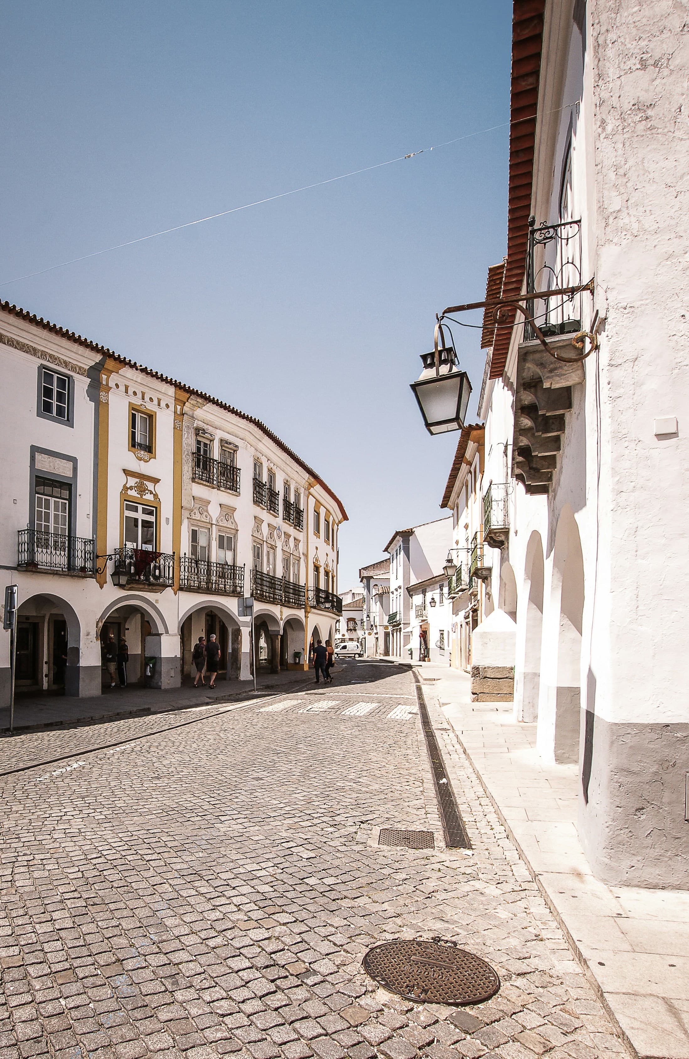 A bright historic square in Évora lined with white-and-ochre buildings