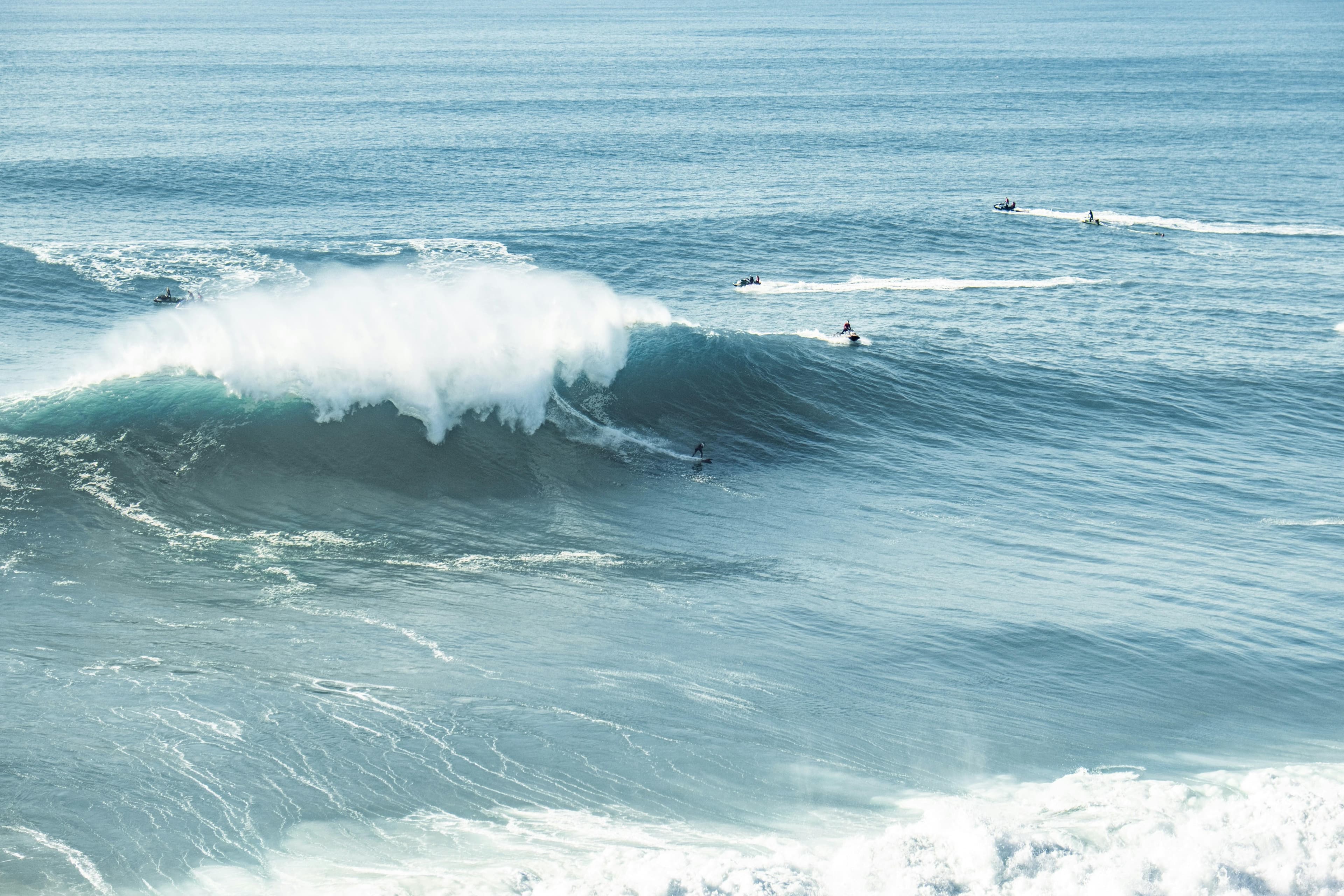 A giant winter wave breaking beside the fort at Nazaré