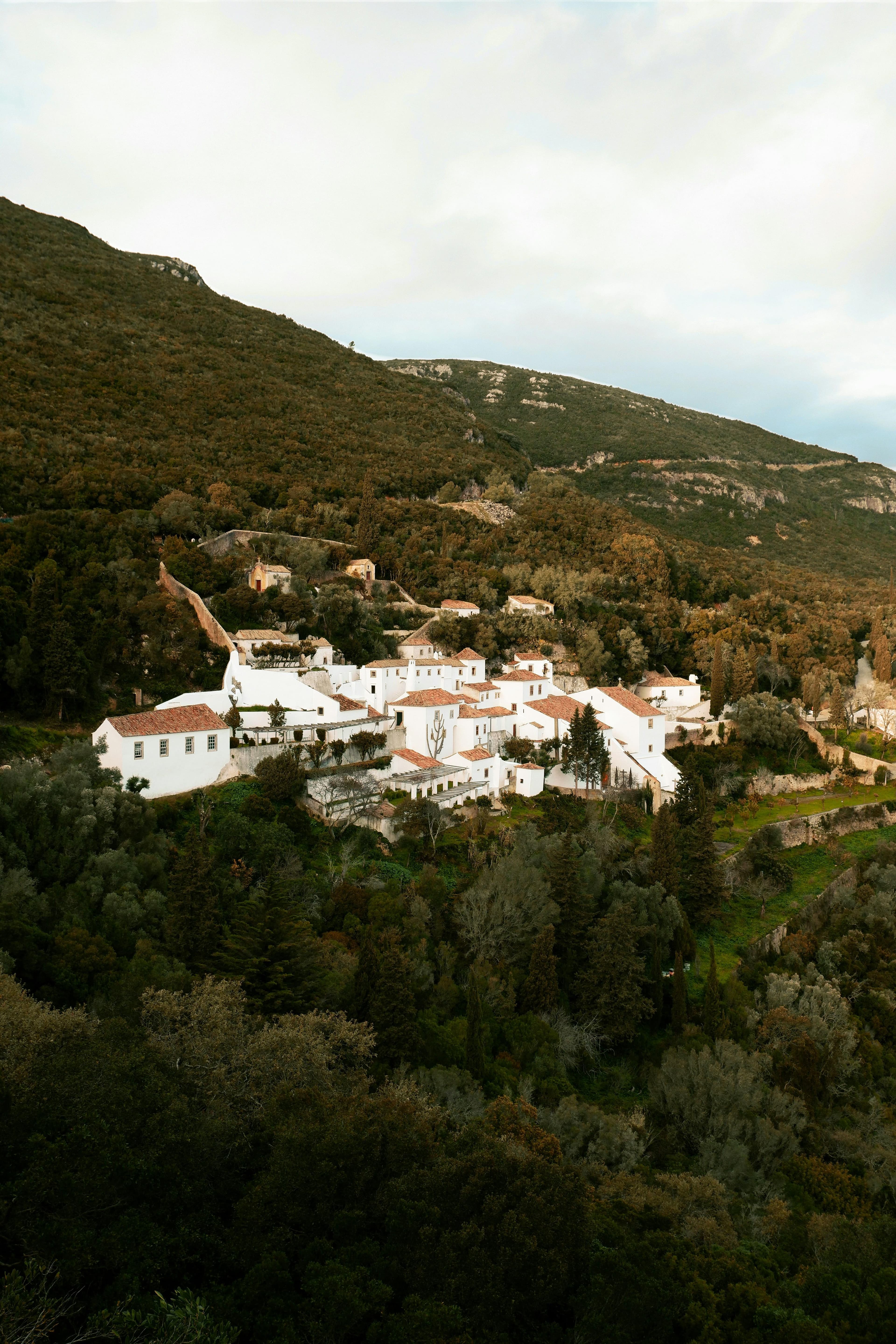 A green mountain valley and white hillside village in Arrábida